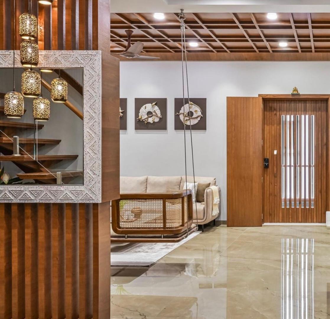 Warm residential interior with wood detailing and a suspended cane chair